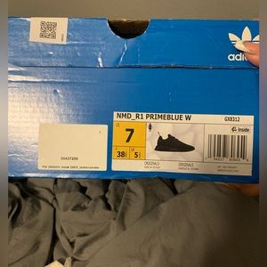 Woman’s black Adidas NMD’s